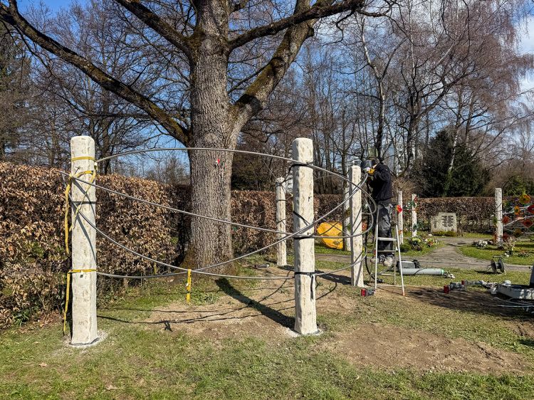 Die Gemeinschafts-Grabanlage Blätter im Wind wird fertiggestellt. Ein Arbeiter poliert die Edelstahl Stangen. Die Gemeinschafts-Grabanlage Blätter im Wind wird fertiggestellt. Ein Arbeiter poliert die Edelstahl Stangen.